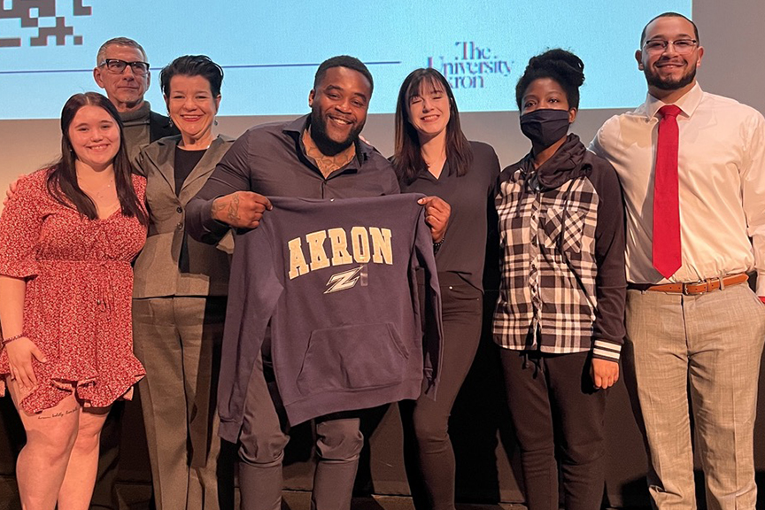 Michael Sutton posing with family and UA students